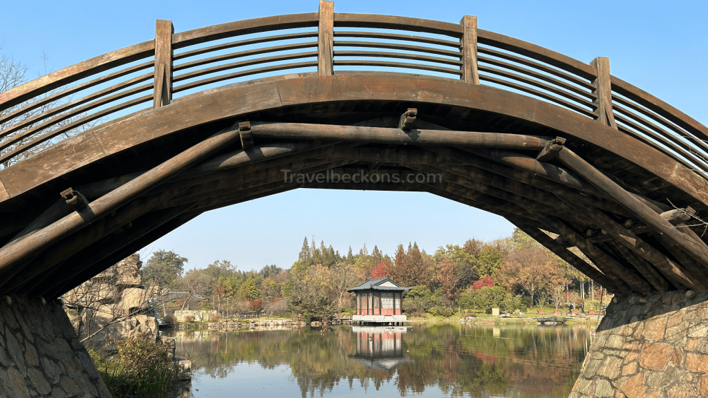 An ancient bridge surrounded by greenery in Slender West Lake Garden, Yangzhou